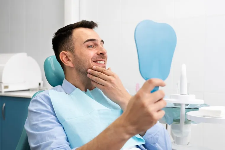Una paziente sorridente si gode il suo nuovo sorriso dopo il trattamento con impianti dentali